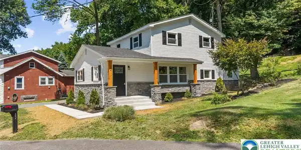 Image 2: A newly updated facade with stone accents and a we
