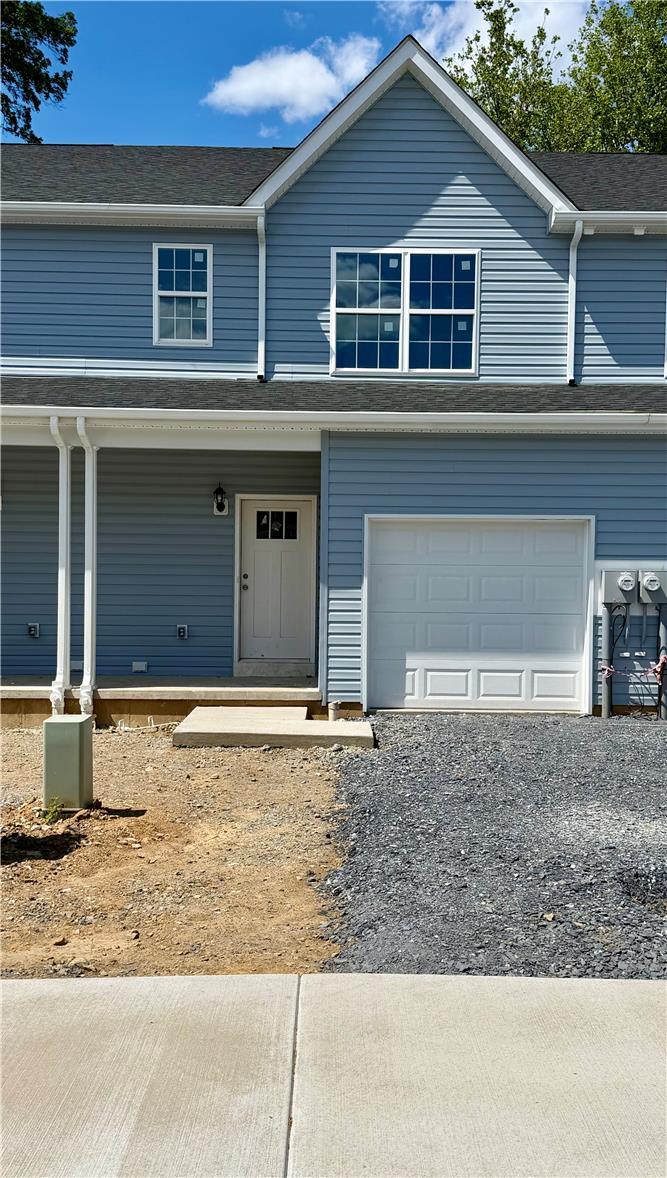 Image 1: A newly constructed residence showcasing light blu