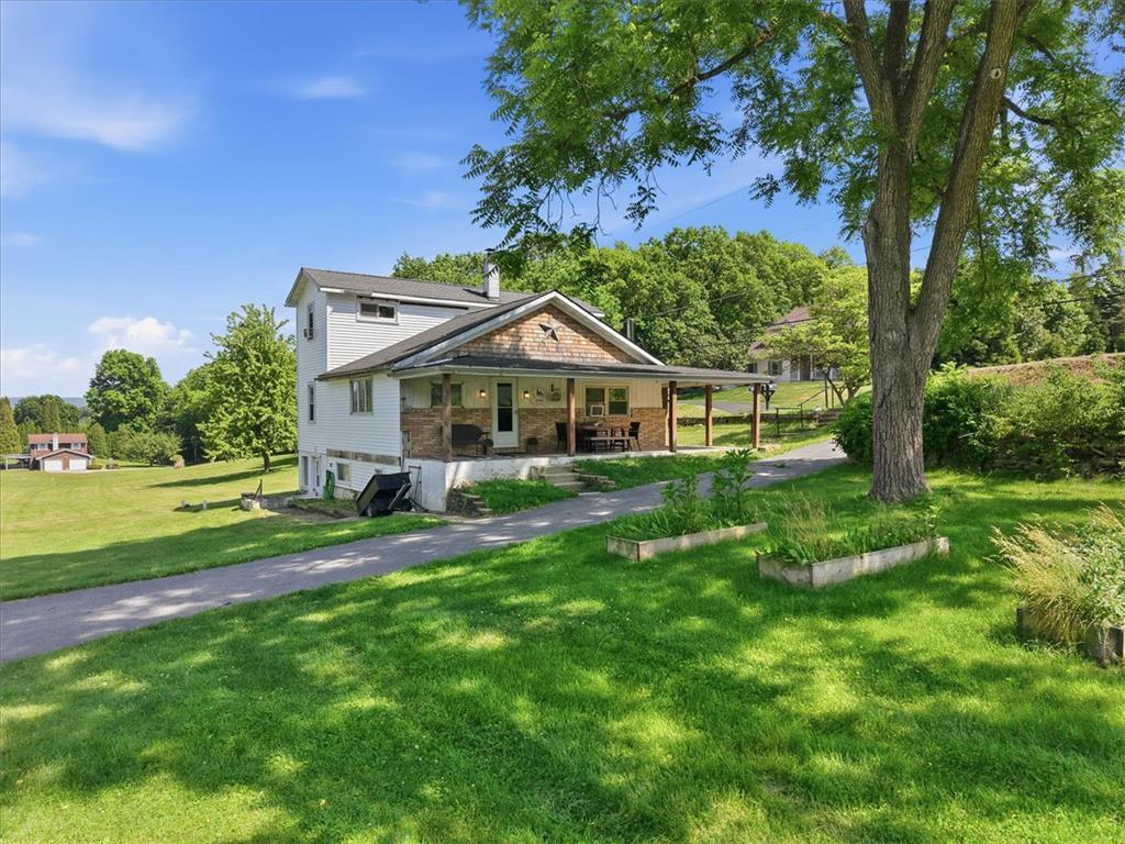 Image 4: A welcoming front porch extends across this charmi
