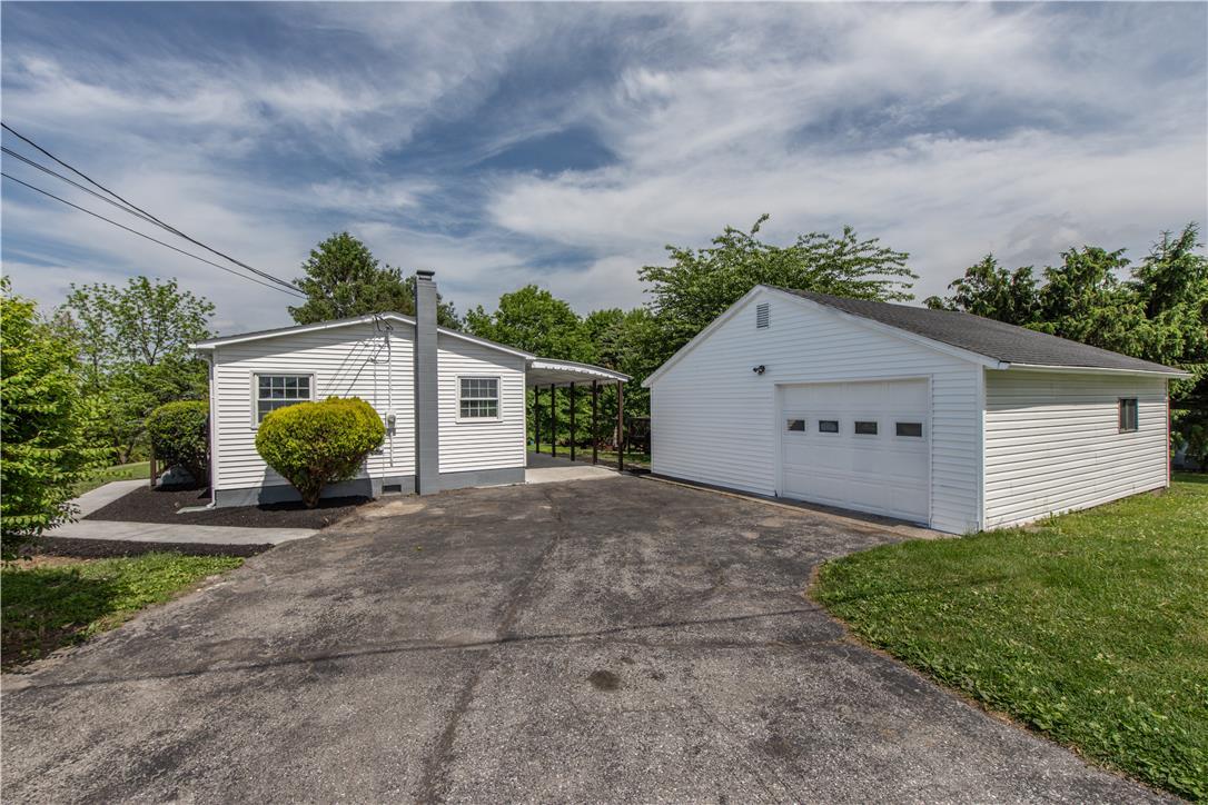 Image 3: White siding and a detached garage define this cha