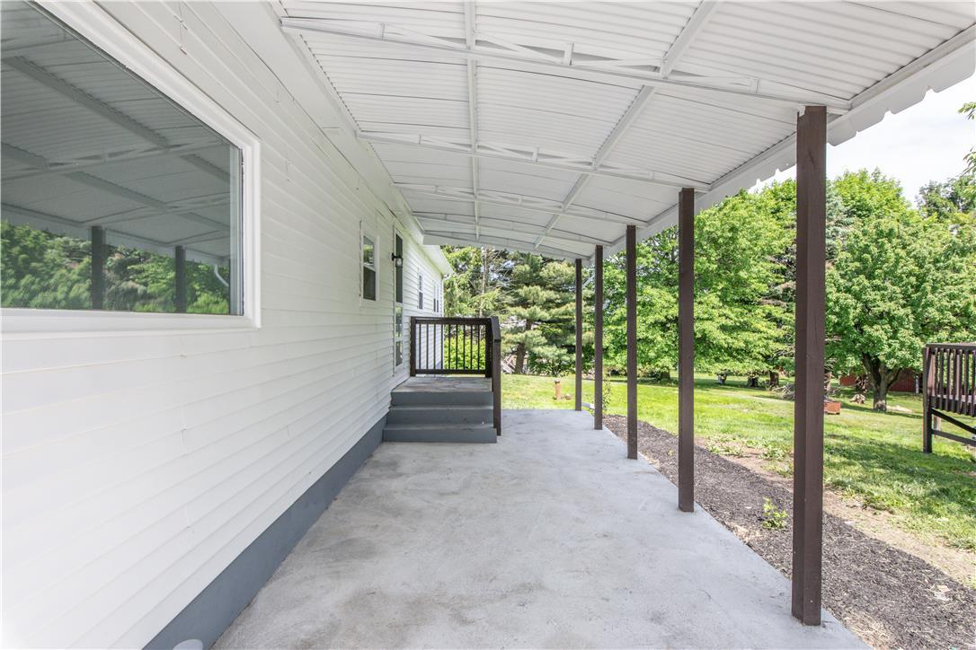 Image 4: A deep covered patio offers ample outdoor living s