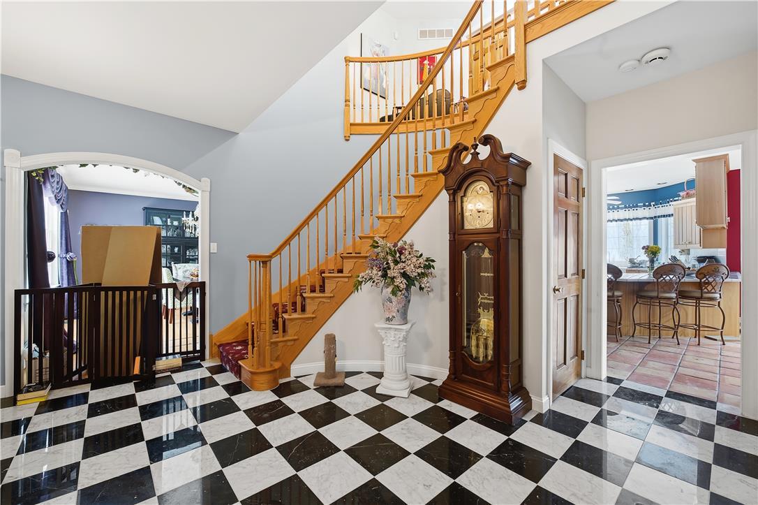 Image 2: A grand wooden staircase with a graceful curve anc