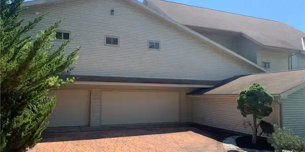 Image 2: An expansive paved driveway leads directly to the
