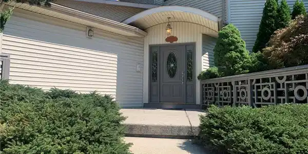 Image 3: An inviting concrete walkway leads directly to the