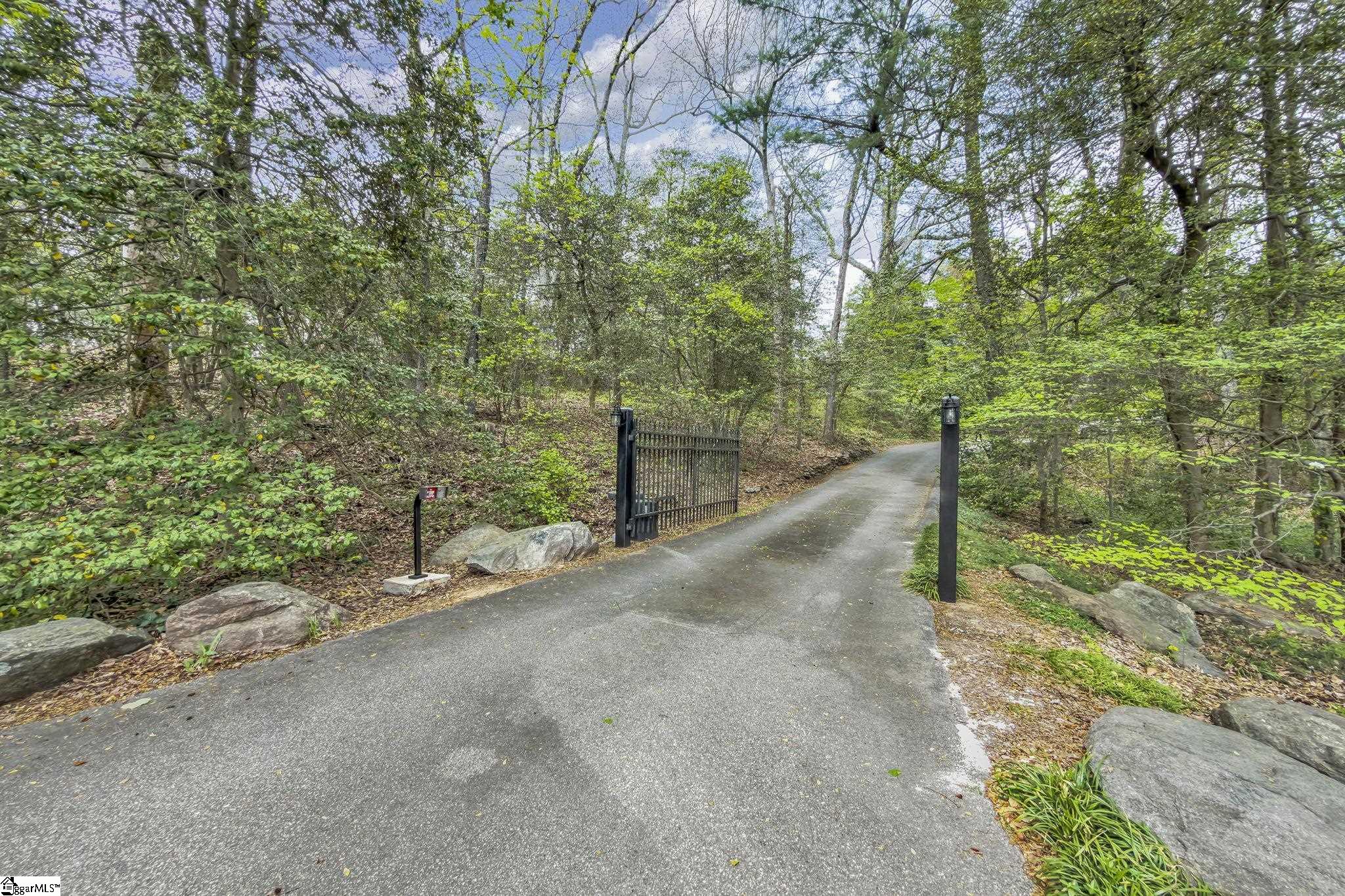 Image 3: Enttire property is fenced. Extensive landscaping including an aroma of tead olives. It will capture you>
