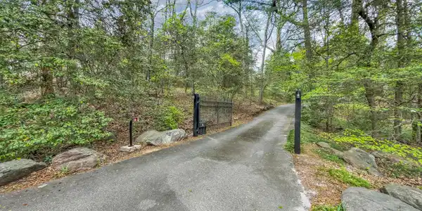 Image 3: Enttire property is fenced. Extensive landscaping including an aroma of tead olives. It will capture you>