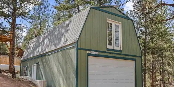 Image 2: two-story, heated and insulated garage with an upper-level bonus room which could be expanded into additional living space.