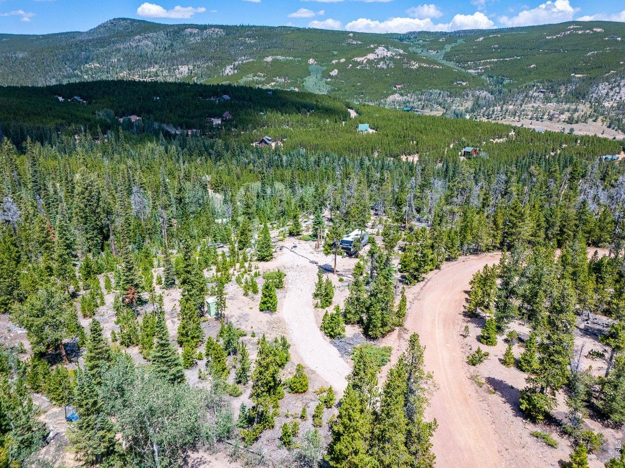 Image 3: Driveway leads in to a level flat camping spot. Image 3: Driveway leads in to a level flat camping spot.