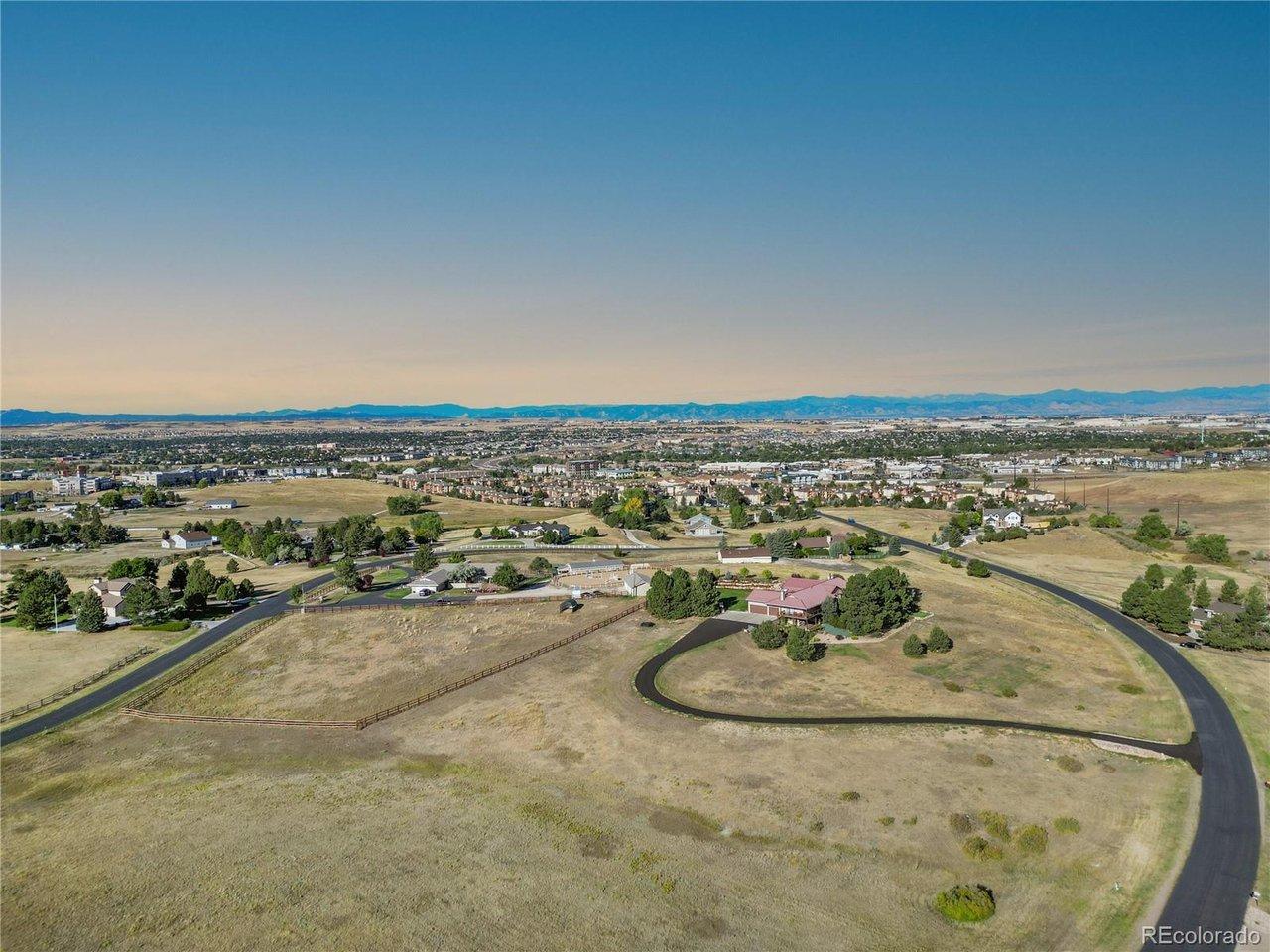 Image 4: Aerial perspective highlighting the full 4.5-acre property, surrounding open space, and panoramic western mountain views.