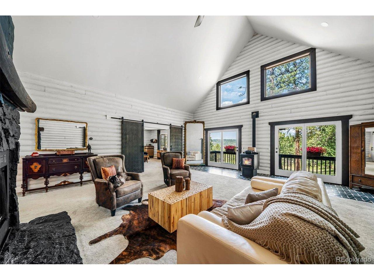 Image 2: Great Room with a main fireplace and woodburning stove Image 2: Great Room with a main fireplace and woodburning stove
