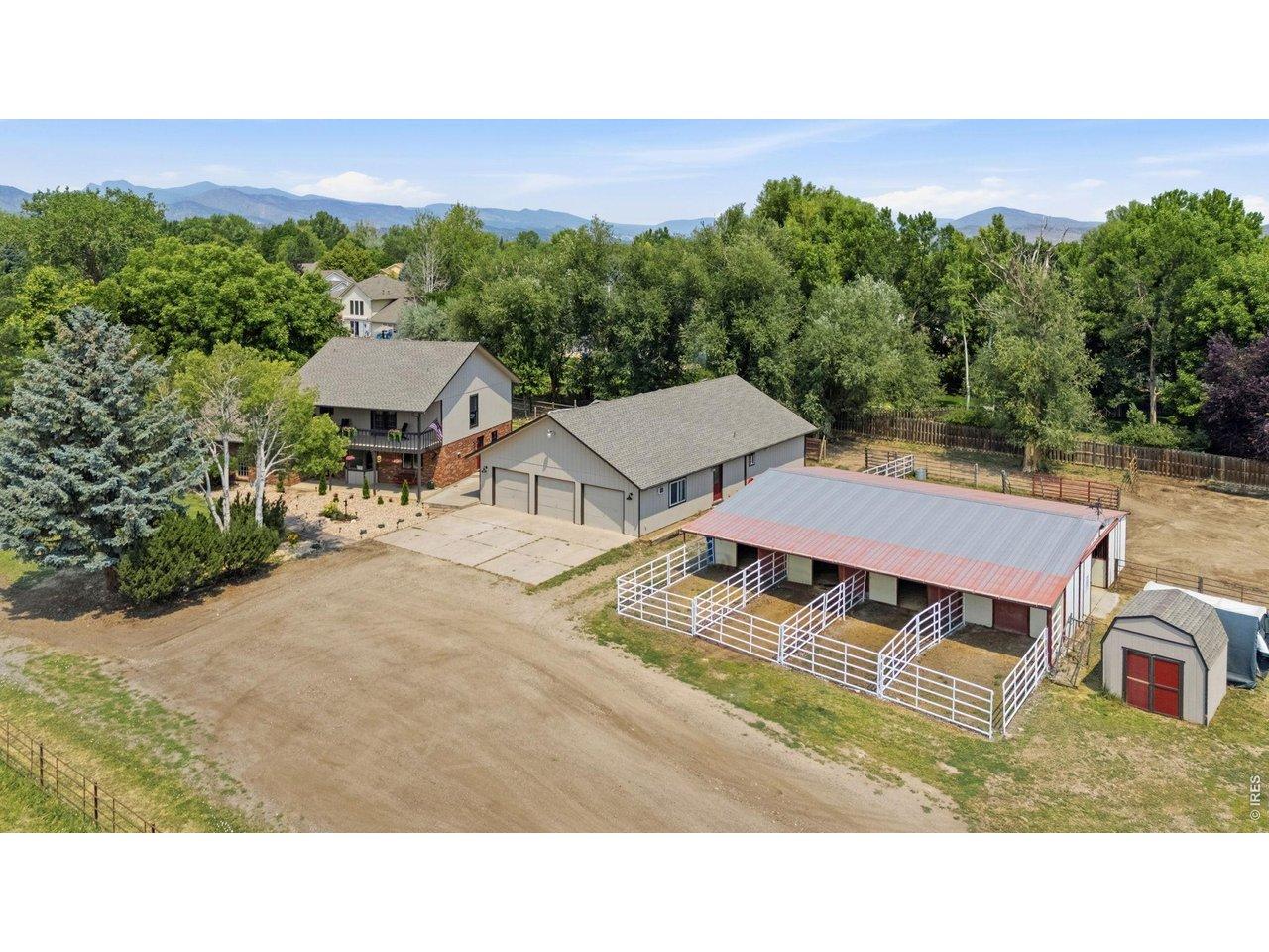 Image 1: Loveland, Colorado horse property with acreage, outbuildings, and mature trees captured from above Image 1: Loveland, Colorado horse property with acreage, outbuildings, and mature trees captured from above