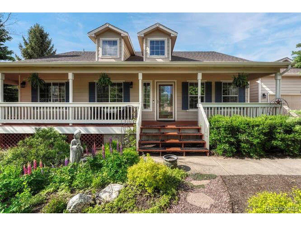 Image 1: Charming two-story house with a wrap-around porch.