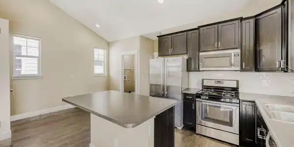 Image 3: Gourmet island kitchen with stainless steel cabinets and a gas stove. Image 3: Gourmet island kitchen with stainless steel cabinets and a gas stove.