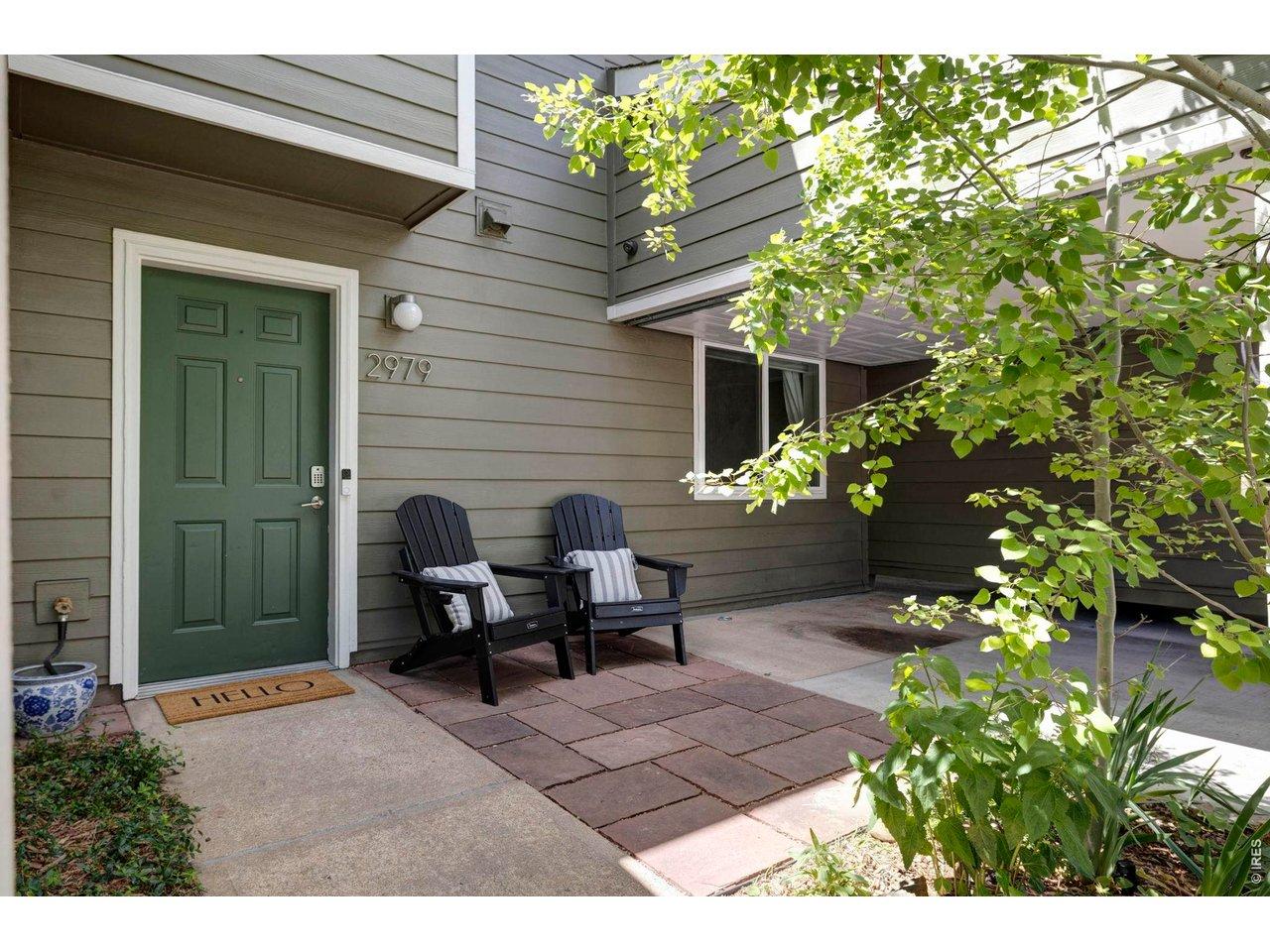 Image 1: An inviting flagstone patio and tidy landscaping welcome you home