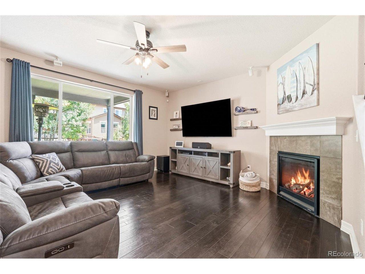 Image 4: Unwind by the lit stone gas fireplace over warm hardwood floors in the family room at 3320 Empire Ave, Frederick CO Image 4: Unwind by the lit stone gas fireplace over warm hardwood floors in the family room at 3320 Empire Ave, Frederick CO