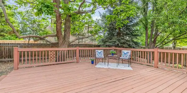 Image 3: Spacious and peaceful back deck shaded by a large catalpa tree