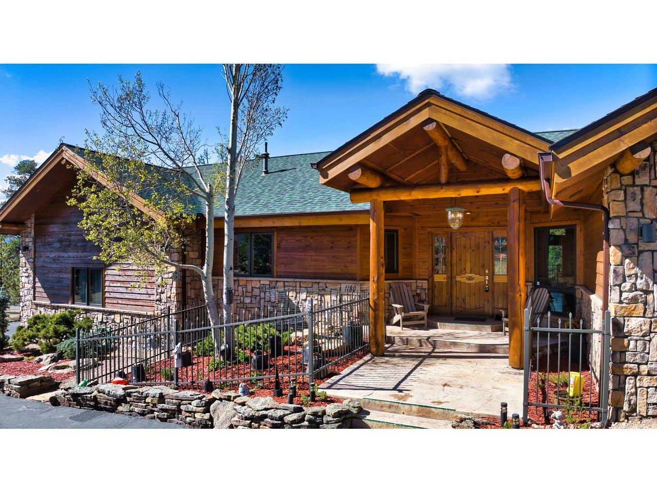 Image 1: Grand covered entry welcomes you with handcrafted timber details and timeless Colorado lodge design. Image 1: Grand covered entry welcomes you with handcrafted timber details and timeless Colorado lodge design.
