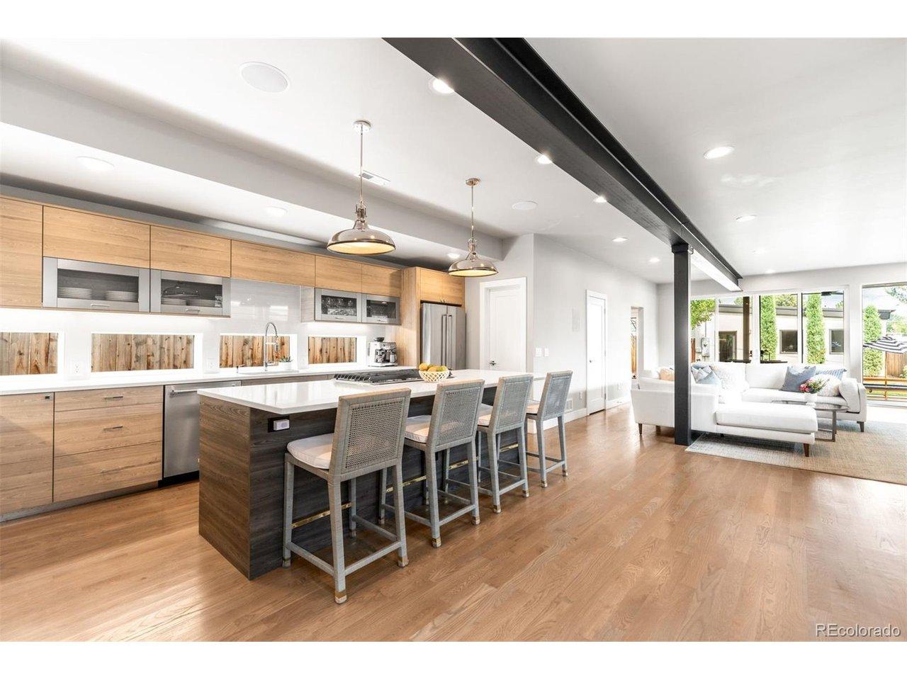 Image 3: The kitchen, dining and living spaces seamlessly flowing at the main level.