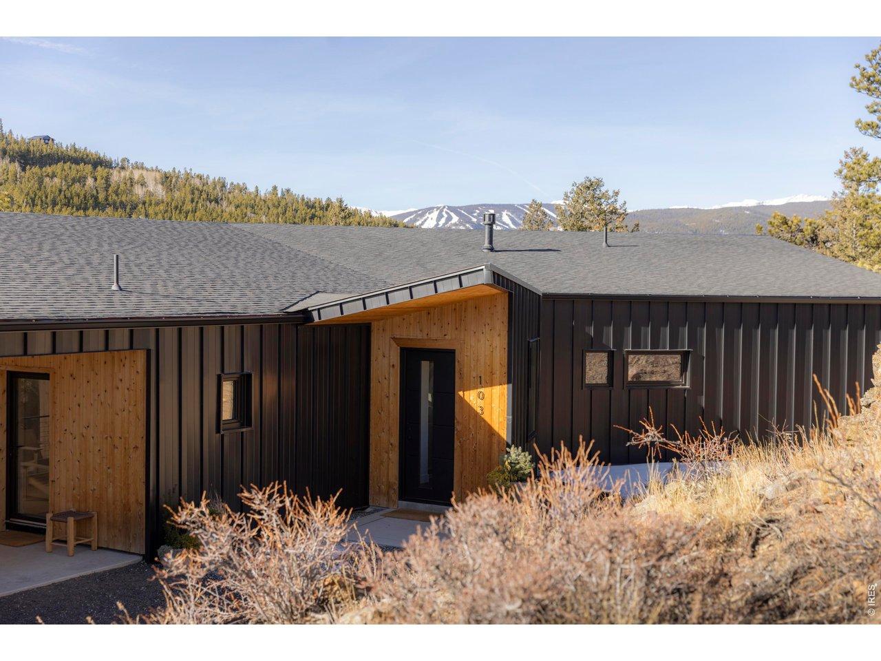 Image 2: Set into the hillside beneath the Indian Peaks, this award-winning modern home pairs dark steel siding with warm cedar accents. Image 2: Set into the hillside beneath the Indian Peaks, this award-winning modern home pairs dark steel siding with warm cedar accents.