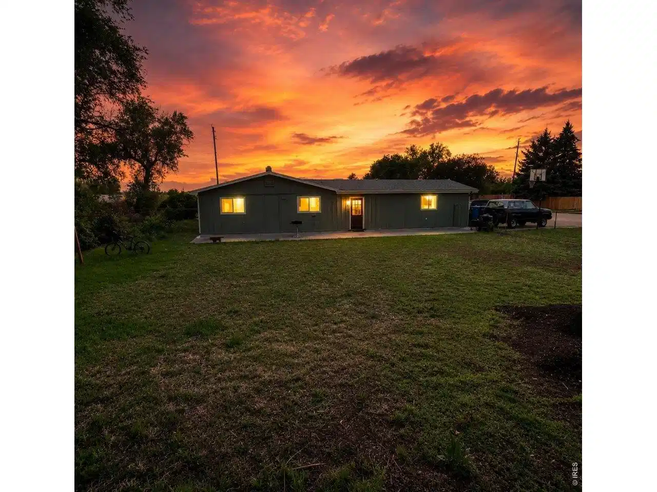 Image 1: Backyard sunset with view of house Image 1: Backyard sunset with view of house