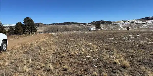 Image 3: View east southeast along the front of the property and Wagon Wheel Road
