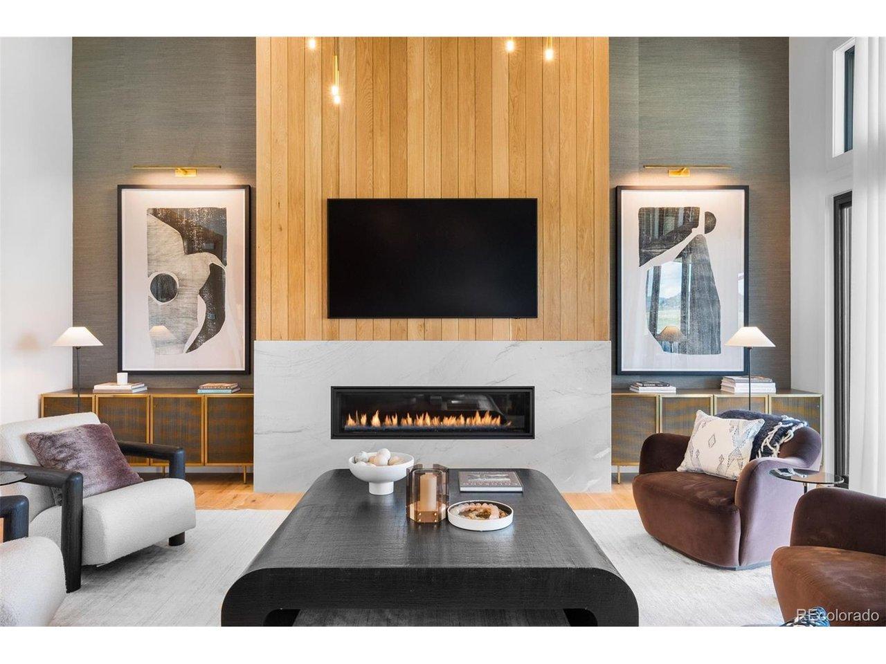 Image 2: White oak and marble fireplace surround creating a refined focal point. Image 2: White oak and marble fireplace surround creating a refined focal point.