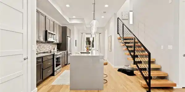 Image 2: Floating oak-and-steel staircase anchors the open main level