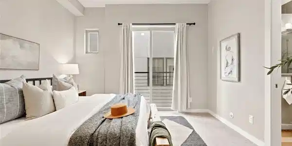 Image 4: Primary bedroom w/ ensuite bath