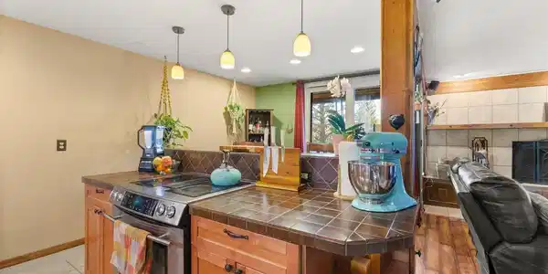 Image 2: Kitchen area with high-end appliances and island seatin