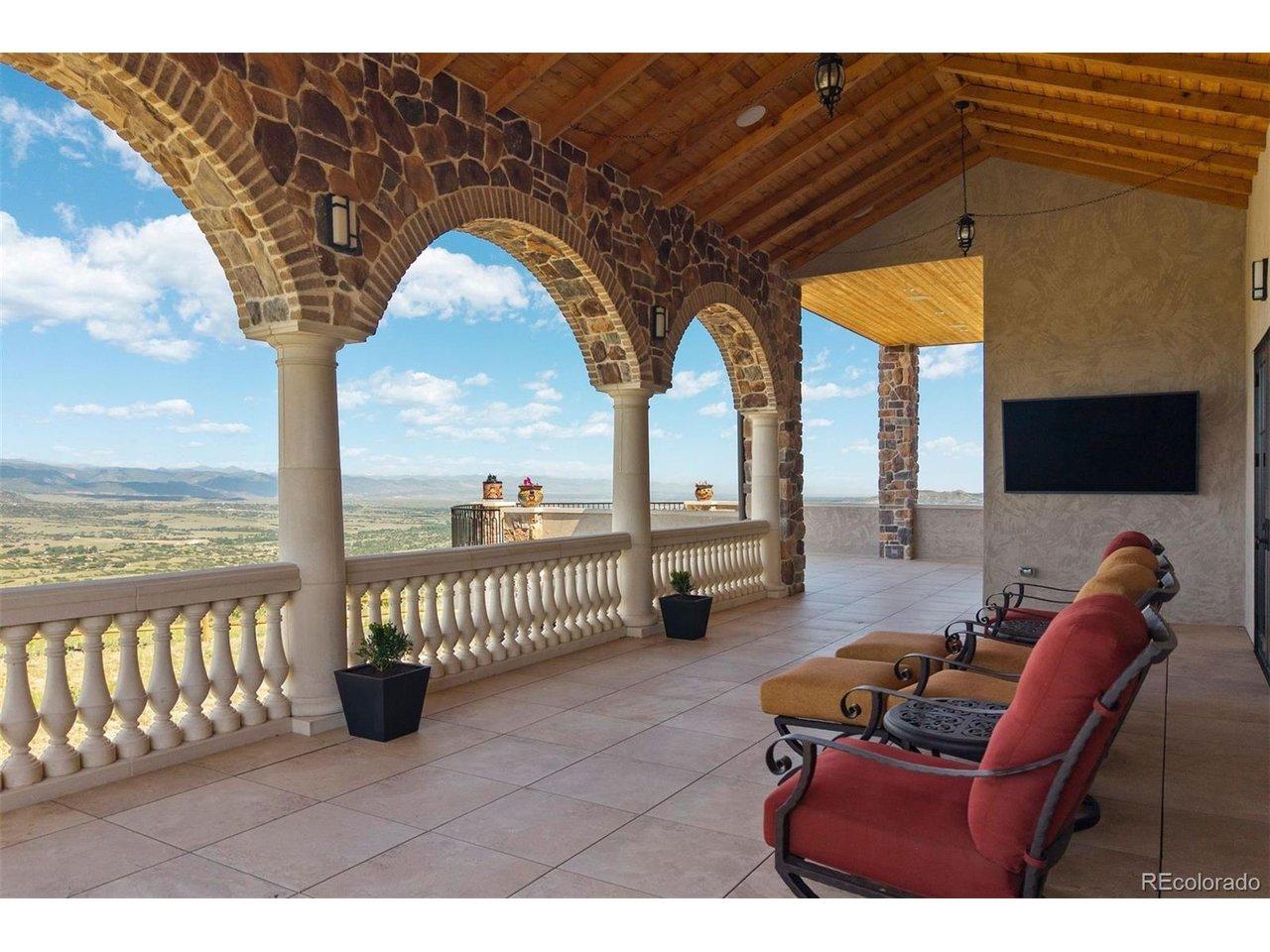 Image 3: Covered deck with stone arches, tongue-and-groove ceiling, and unobstructed Front Range views. Image 3: Covered deck with stone arches, tongue-and-groove ceiling, and unobstructed Front Range views.