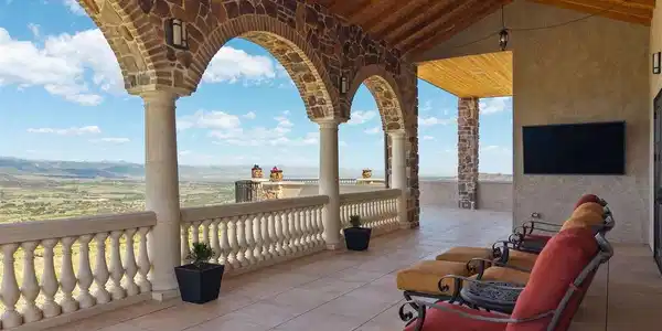 Image 3: Covered deck with stone arches, tongue-and-groove ceiling, and unobstructed Front Range views. Image 3: Covered deck with stone arches, tongue-and-groove ceiling, and unobstructed Front Range views.