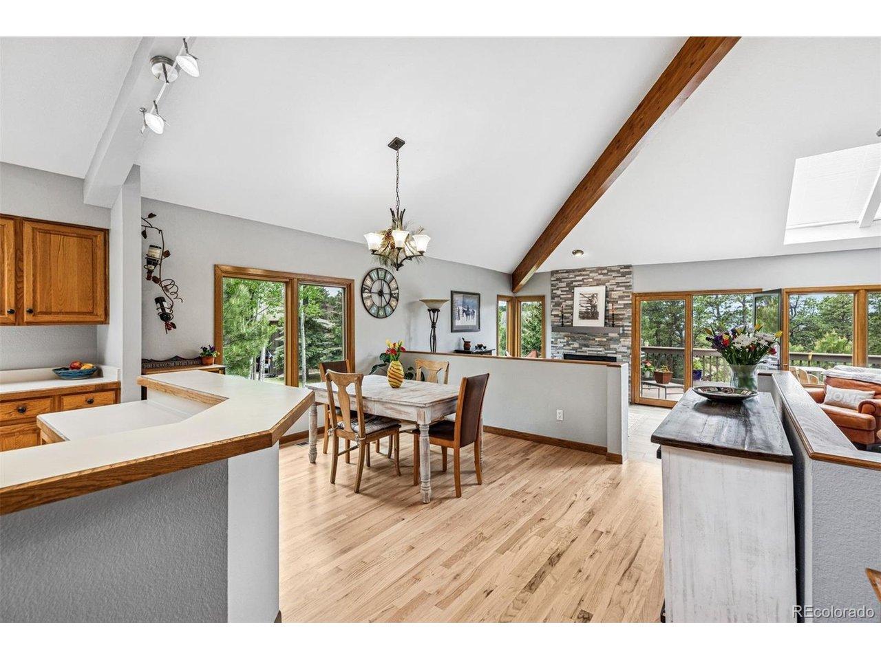 Image 4: Open floor plan with vaulted ceiling and wood beams Image 4: Open floor plan with vaulted ceiling and wood beams