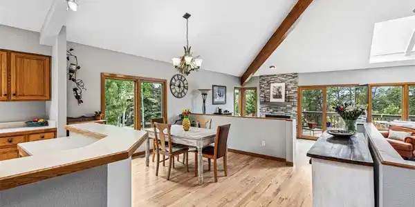 Image 4: Open floor plan with vaulted ceiling and wood beams Image 4: Open floor plan with vaulted ceiling and wood beams