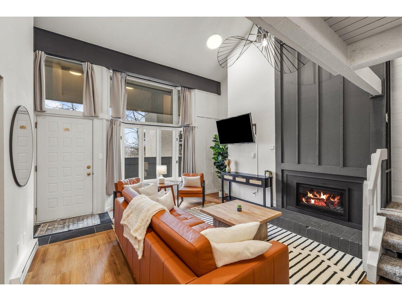 Image 2: A dramatic floor-to-ceiling fireplace surround anchors this stunning great room, where designer finishes and curated furnishings create an atmosphere of effortless sophistication.