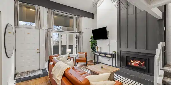 Image 2: A dramatic floor-to-ceiling fireplace surround anchors this stunning great room, where designer finishes and curated furnishings create an atmosphere of effortless sophistication. Image 2: A dramatic floor-to-ceiling fireplace surround anchors this stunning great room, where designer finishes and curated furnishings create an atmosphere of effortless sophistication.