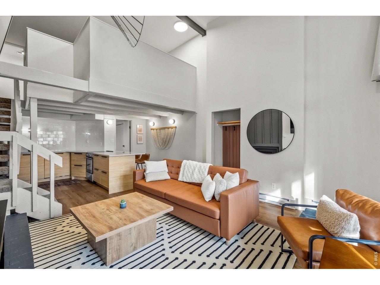Image 4: Soaring beamed ceilings, rich hardwood floors, and an effortless open flow create a living space that is equal parts stylish and inviting.