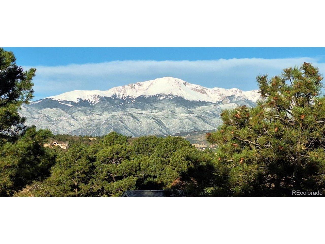 Image 2: Snowy view of Pikes Peak from deck