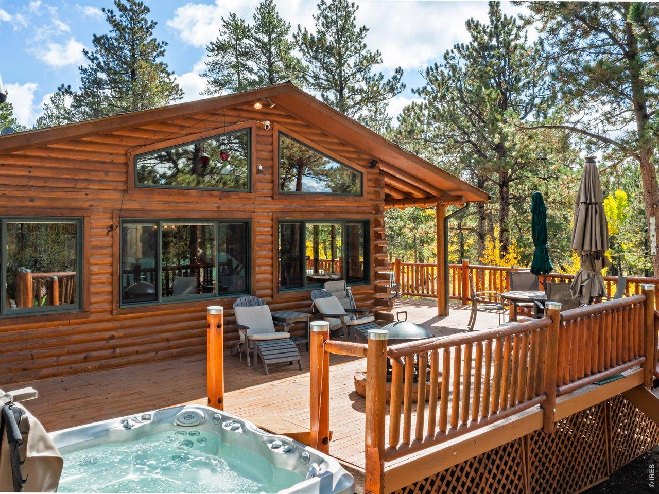 Image 2: The house facing West, offering 0ptimal outdoor living space. What better place to curl up and read a book, soak in the hot tub or cuddle with your significant other?