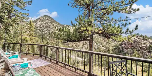 Image 2: Expansive deck overlooking the surrounding mountains and pines