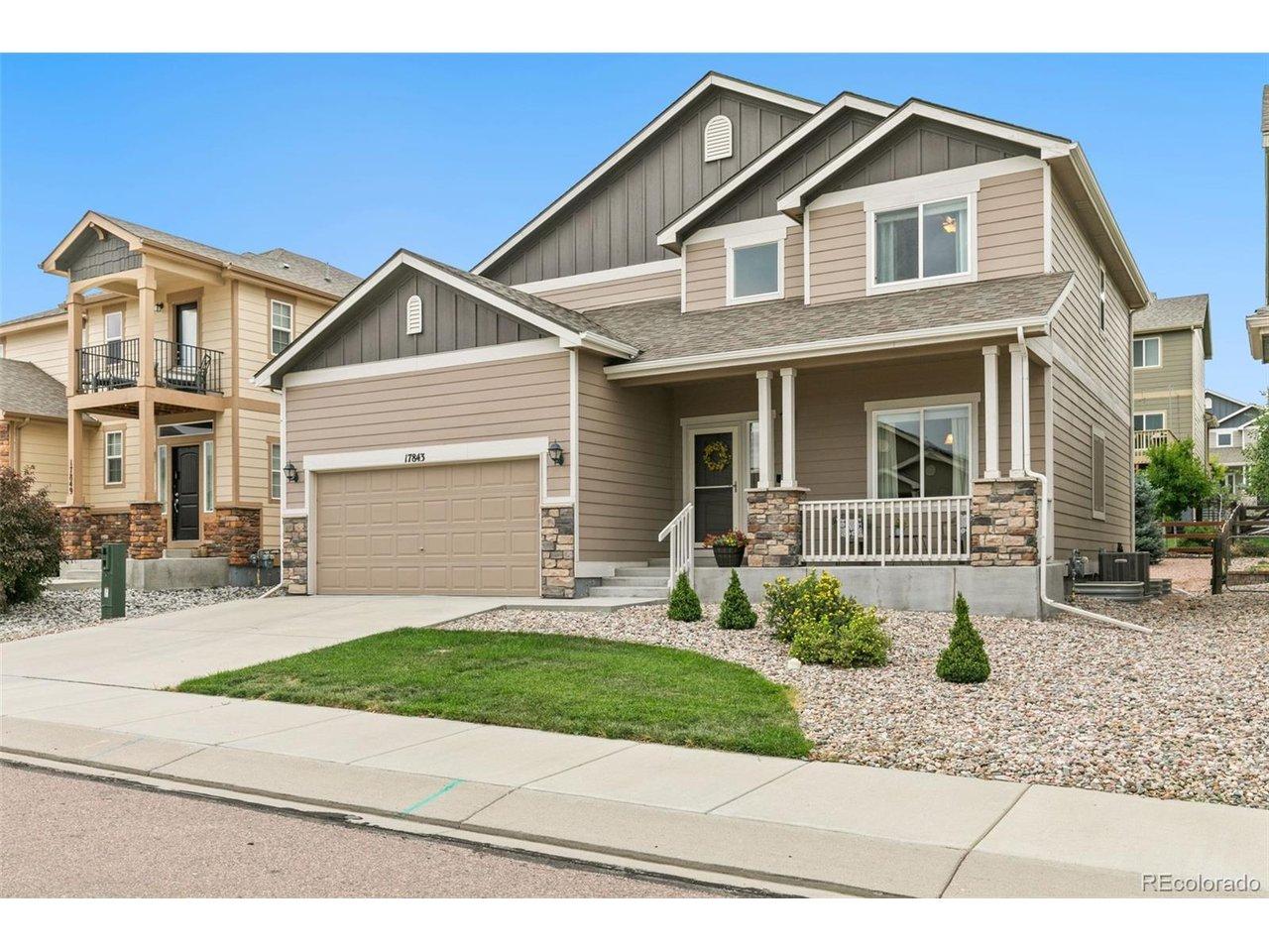 Image 1: Front of home, with low maintenace landscaping a welcoming front porch