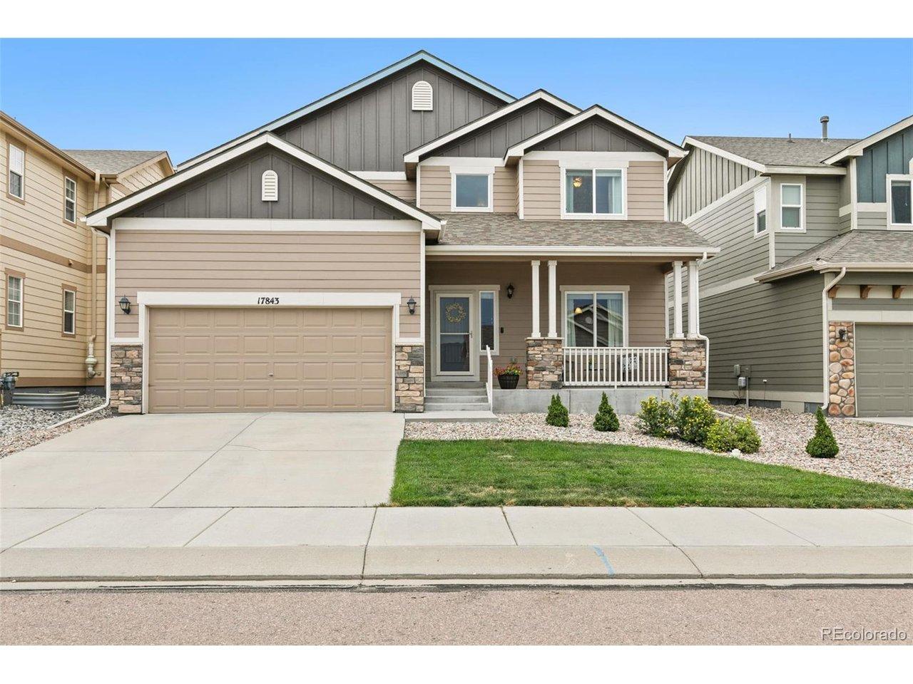 Image 2: Front of home, with low maintenace landscaping a welcoming front porch