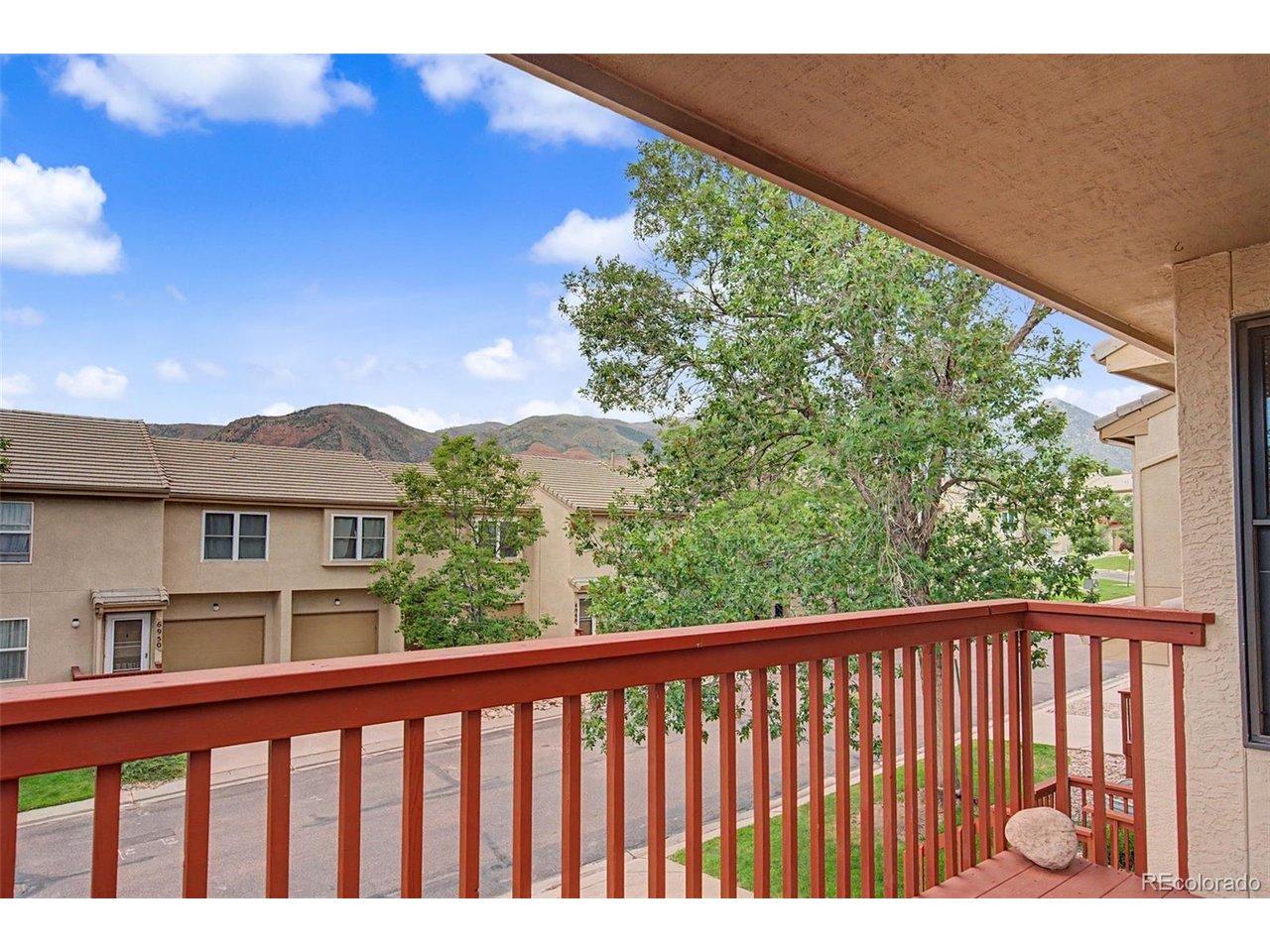Image 4: Enjoy the mountain top and mature tree views in Colorado's beautiful outdoor weather from the comforts of the home's covered front balcony! Image 4: Enjoy the mountain top and mature tree views in Colorado's beautiful outdoor weather from the comforts of the home's covered front balcony!