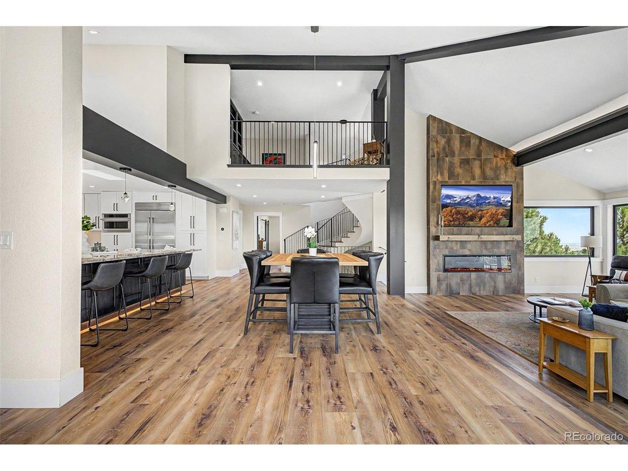 Image 3: Perfectly positioned between the gourmet kitchen and spectacular great room, the dining area serves as a wonderful gathering please. Soaring vaulted ceilings, striking architectural beams, and an open loft above create an impressive sense of scale, while c Image 3: Perfectly positioned between the gourmet kitchen and spectacular great room, the dining area serves as a wonderful gathering please. Soaring vaulted ceilings, striking architectural beams, and an open loft above create an impressive sense of scale, while c