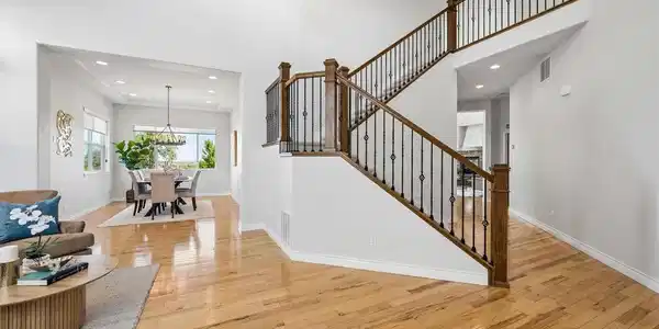 Image 3: Elegant staircase with wood railings and iron balusters. Image 3: Elegant staircase with wood railings and iron balusters.