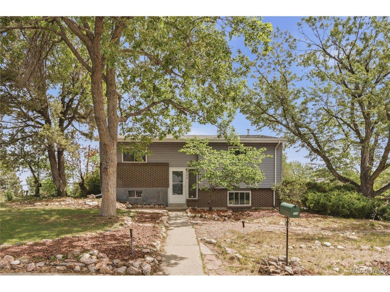 Image 2: Set back from the street and framed by mature trees, 804 S. Queen Way sits on a 10,411 sq ft corner lot in Lakewood with easy access to 6th Ave, Main Reservoir, and Green Mountain trails. Image 2: Set back from the street and framed by mature trees, 804 S. Queen Way sits on a 10,411 sq ft corner lot in Lakewood with easy access to 6th Ave, Main Reservoir, and Green Mountain trails.