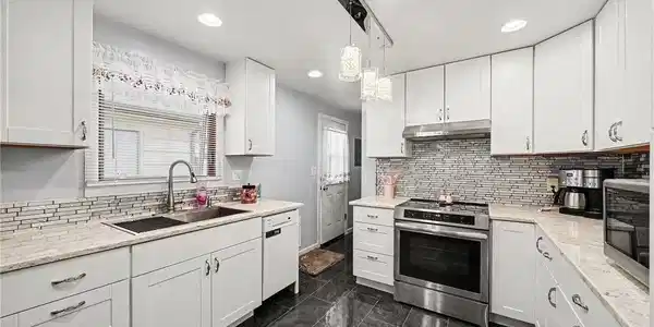Image 2: Remodeled kitchen with stainless steel appliances