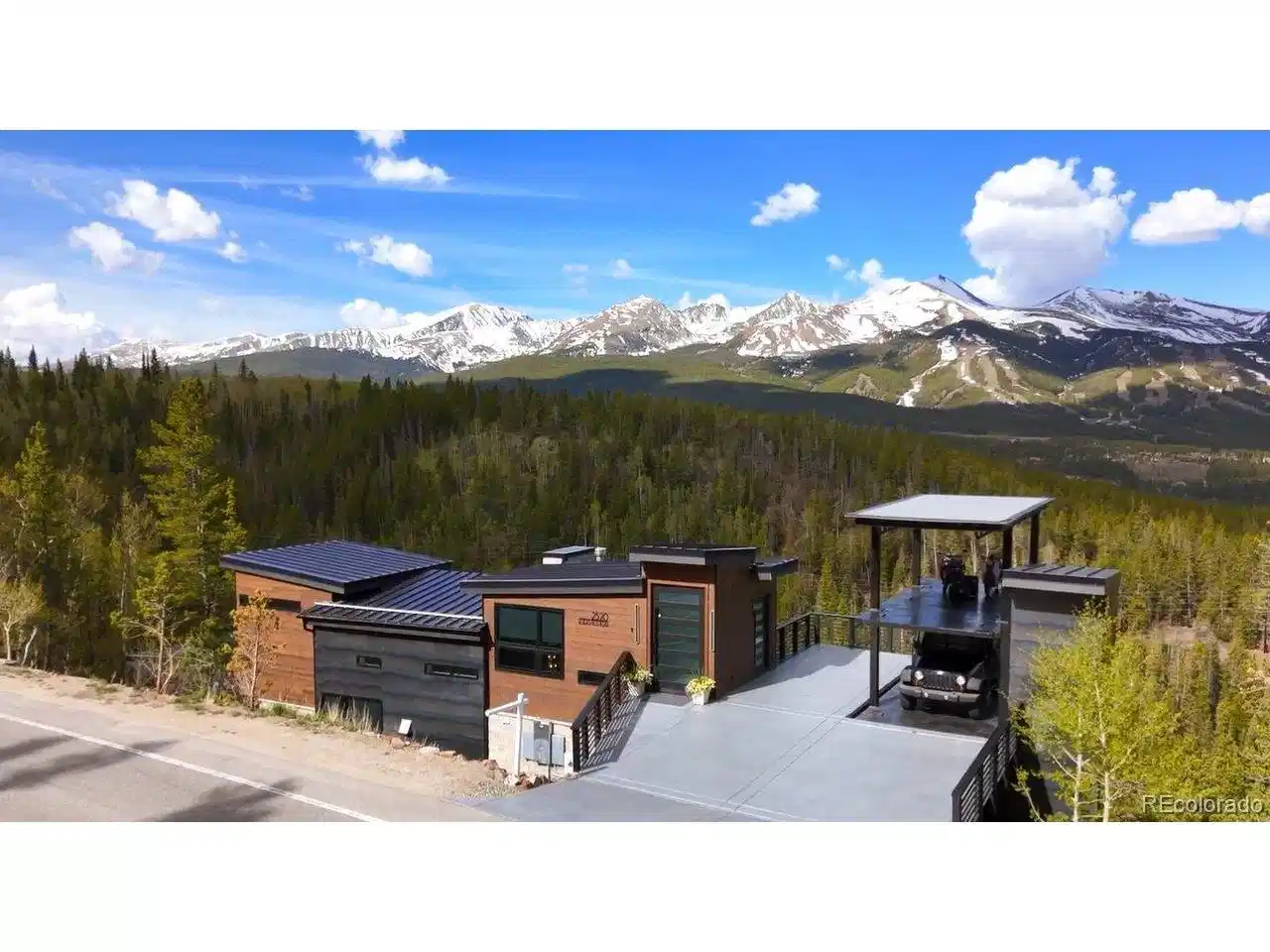 Image 1: Stunning view of the entire 10 mile range. 2-story hydraulic car-lift garage features a durable polyspartic car deck finish, 2-car subterranean storage, + room for 6 vehicles above-an exceptionally rare feature.