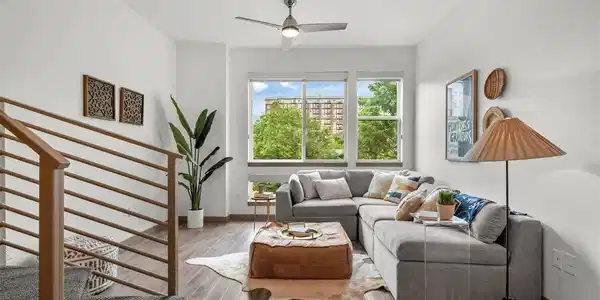 Image 2: Living room with extra tall ceilings and lots of natural light.