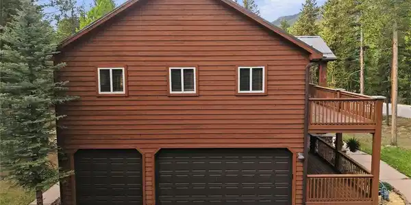 Image 4: 3-Car attached garage with paved driveway, front porch deck and upper deck. Image 4: 3-Car attached garage with paved driveway, front porch deck and upper deck.