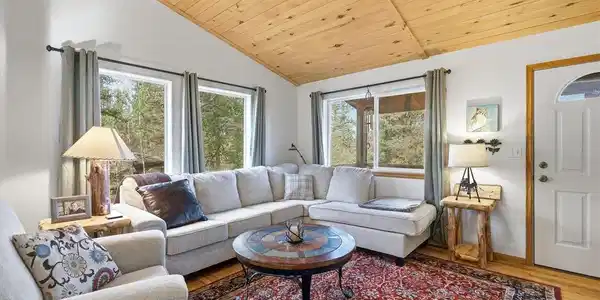 Image 2: Bright living area with windows framing the surrounding pines Image 2: Bright living area with windows framing the surrounding pines